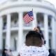 A child waves an American flag during a Fourth of July celebration with frontline workers and military families, Sunday, July 4, 2021, on the South Lawn of the White House. (Official White House photo by Chandler West)